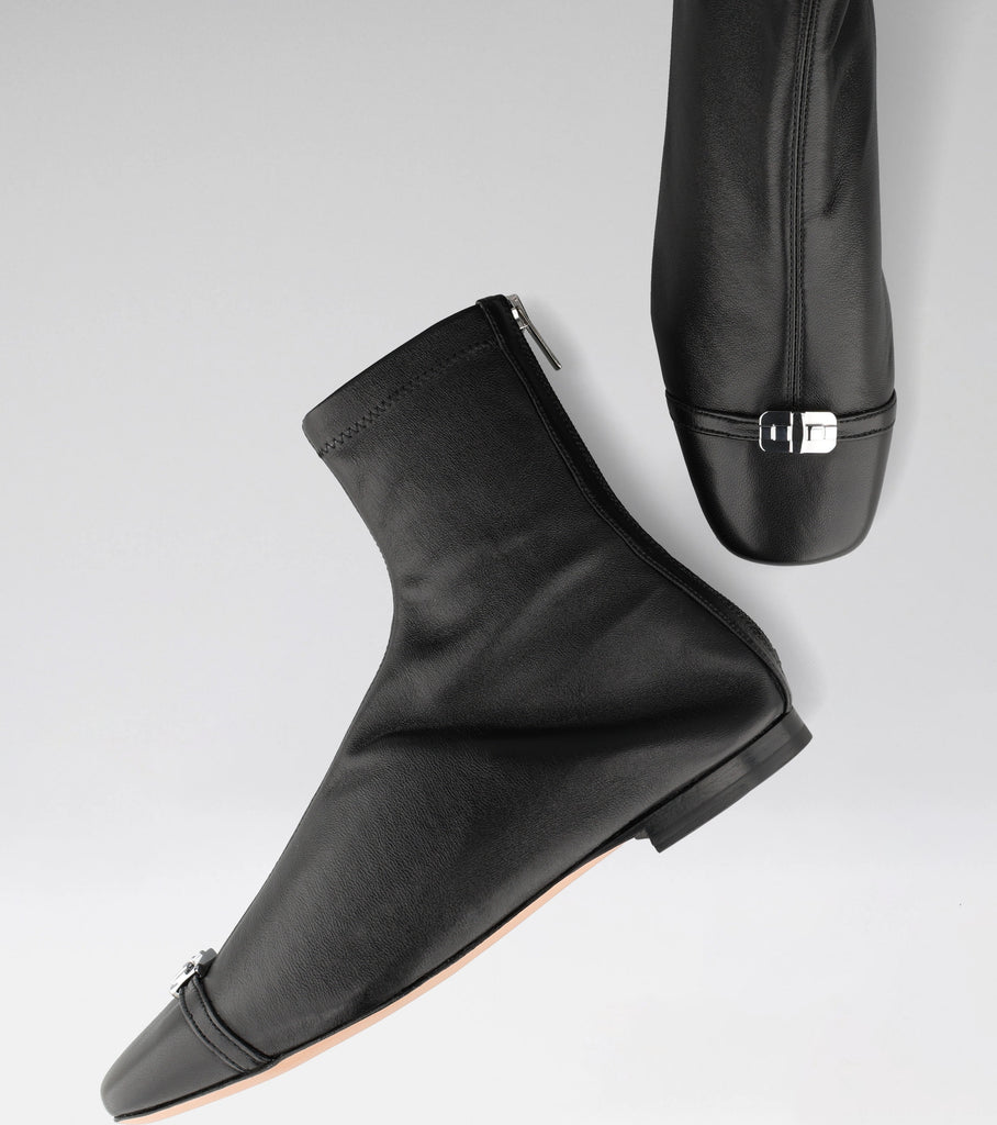 AMAL black leather flat with a squared toe and MOROBÉ brooch.