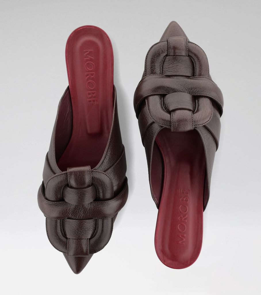 MARIANE backless leather mule with a pointed toe and MOROBÉ brooch.
