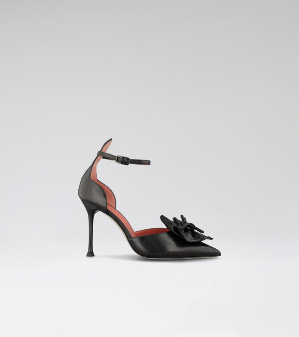 high heel pumps with a flower in the front of the toe 